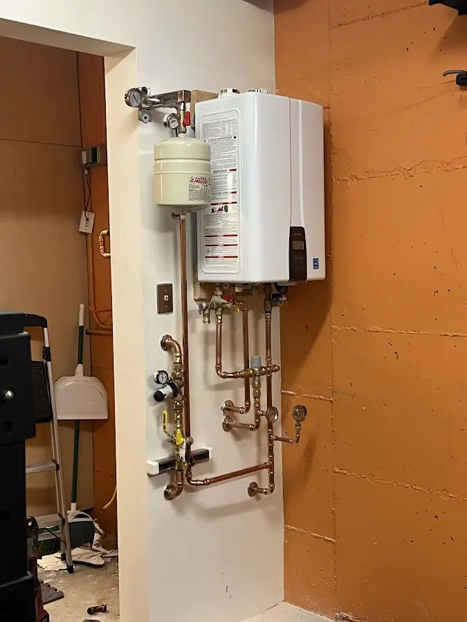 Plumbing technician inspecting water heater connections in Redlands